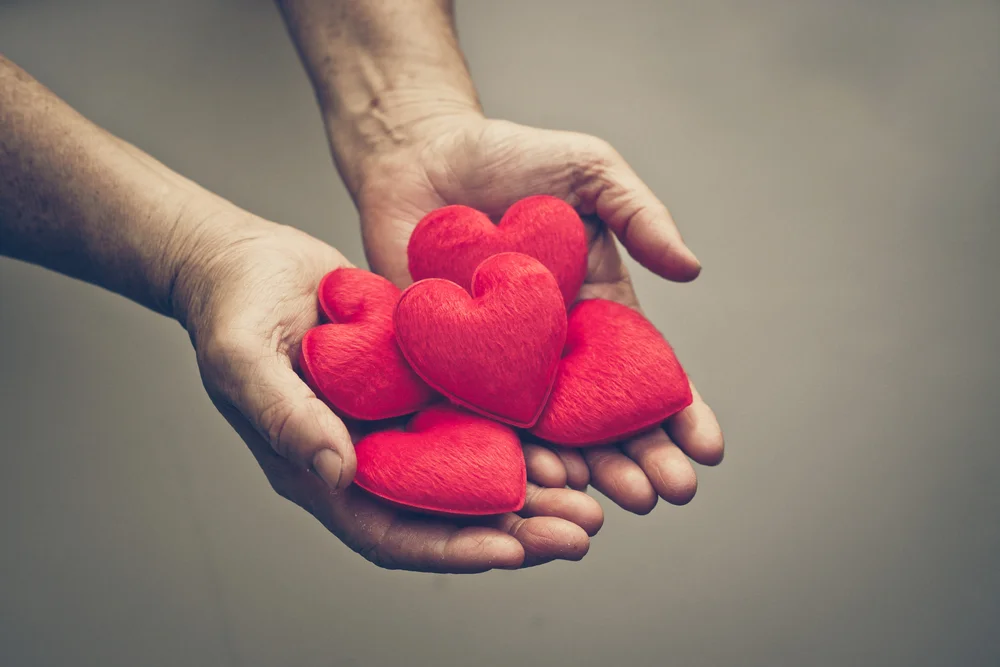 Older woman holding a bunch of hearts